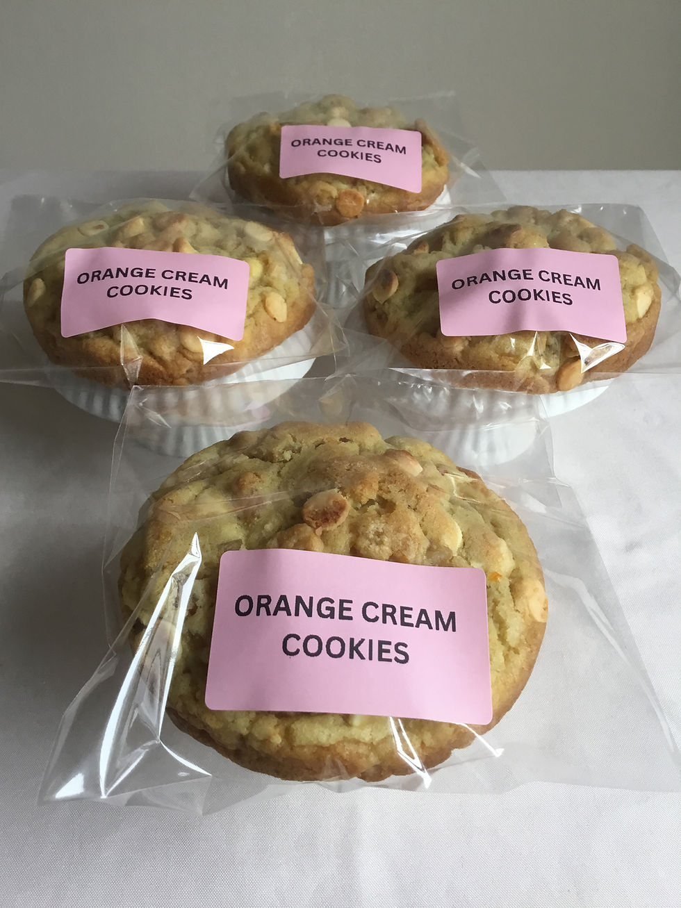 Packaged thick orange cookies with white chocolate chips