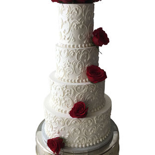 4 Tier buttercream wedding cake, decorated buttercream scrolls, buttercream bead borders and fresh flowers.
Fresh flowers were provided by bride and attached to the cake when it was delivered.
