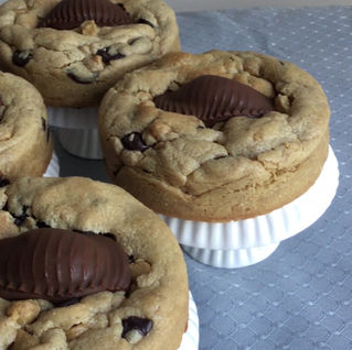 Thick peanut butter cookies with chocolate chips topped with Reese's peanut butter cups and coarse salt