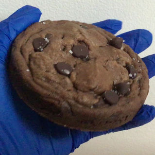 Video close up view of thick chocolate chocolate chip cookies, sprinkled with coarse salt.