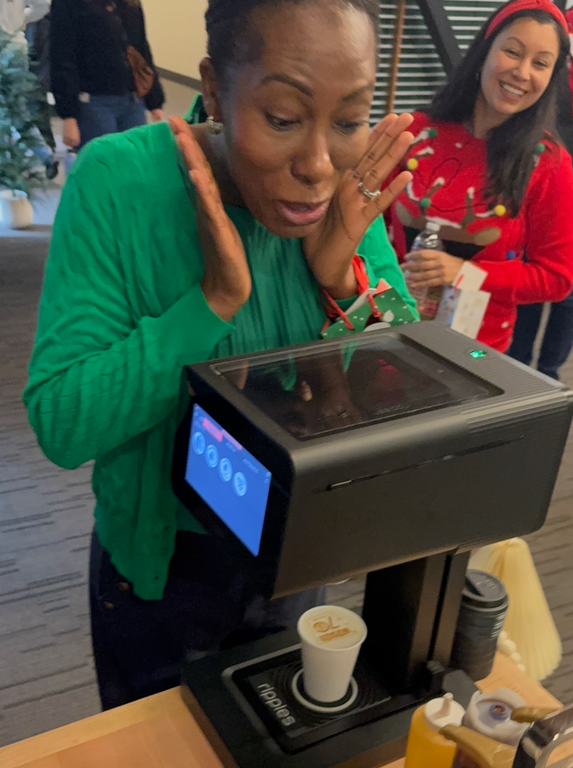 A woman is surprised at how beautiful her coffee print came out. 