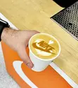 Latte art with Nike swoosh on orange mat from white-label coffee activation event in Portland Oregon
