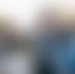 father of the bride talking with guests while holding an iced coffee