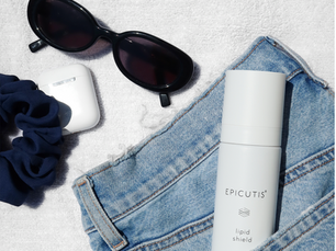 Epicutis Lipid Shield sunscreen in a denim pocket with sunglasses on a white towel, available at Horizon Med Spa in Kansas City