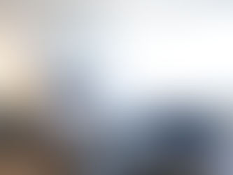 A view of a warm and cozy private suite bedroom with sunlight beaming in from the window at Victoria Landing where guests can stay while they visit their loved ones.