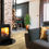 Thumbnail: Arundel Wood in a living setting where you can see a couch and the log burner next to the couch