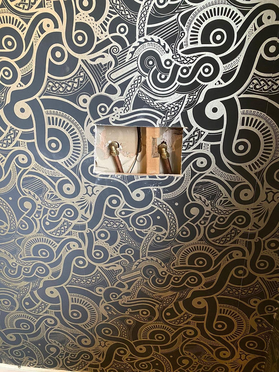 Exposing the pipe work with a hole in the wall