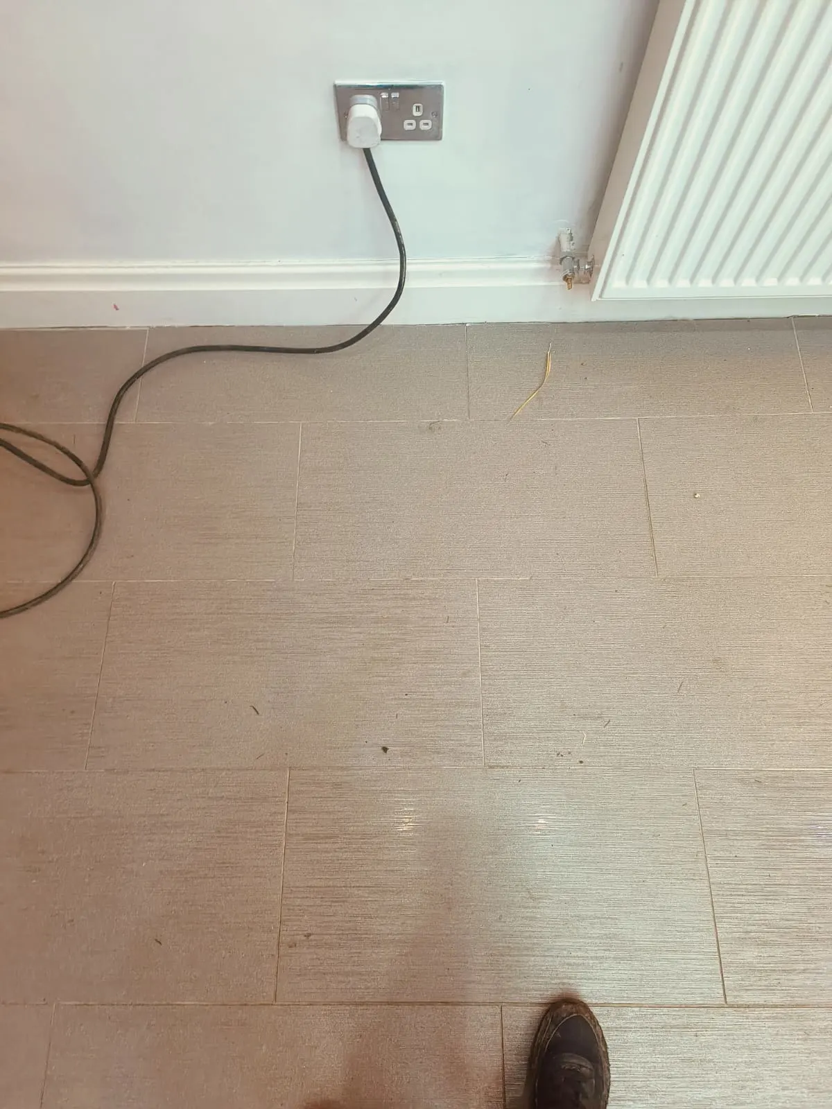 A tiled kitchen floorA tiled kitchen floor where the hole was now repaired. where the hole was now repaired