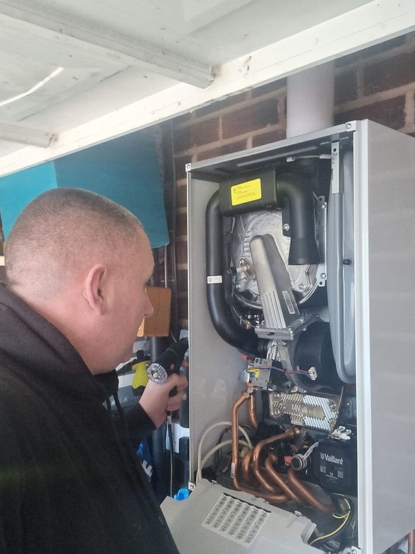 Team member repairing a boiler