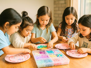 5 young girls doing a colourful indoor beading activity at home in Vancouver