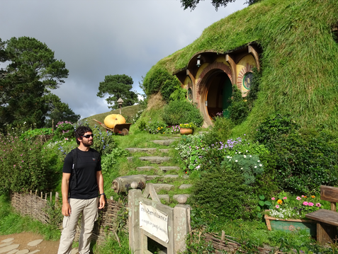 Guy stands in front of Bilbo's home in the shire