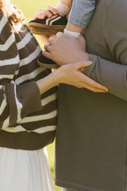 Detail photograph of hands and feet of a toddler during a family session