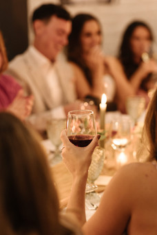 A glass of wine held high during a toast