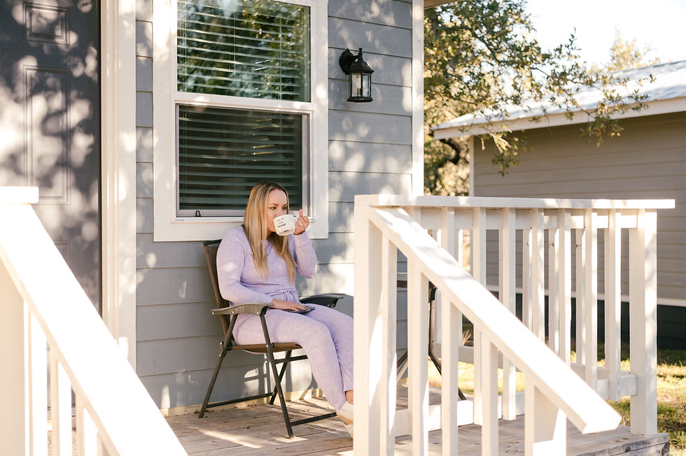 Guest relaxing on private cottage porch at Wrenwood Ranch Hill Country wedding venue with lodging Johnson City Texas near Fredericksburg
