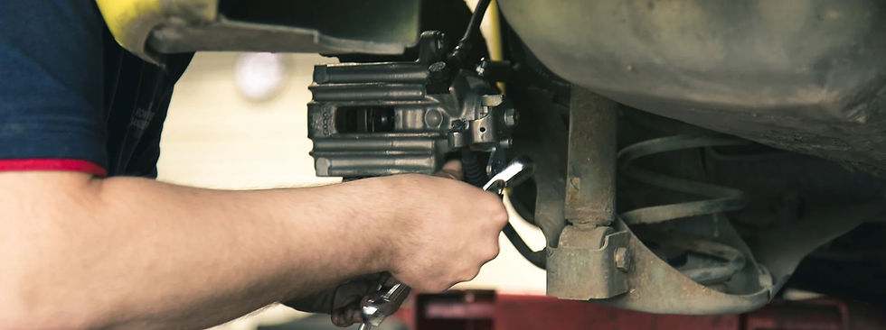 Mechanic working on car brakes