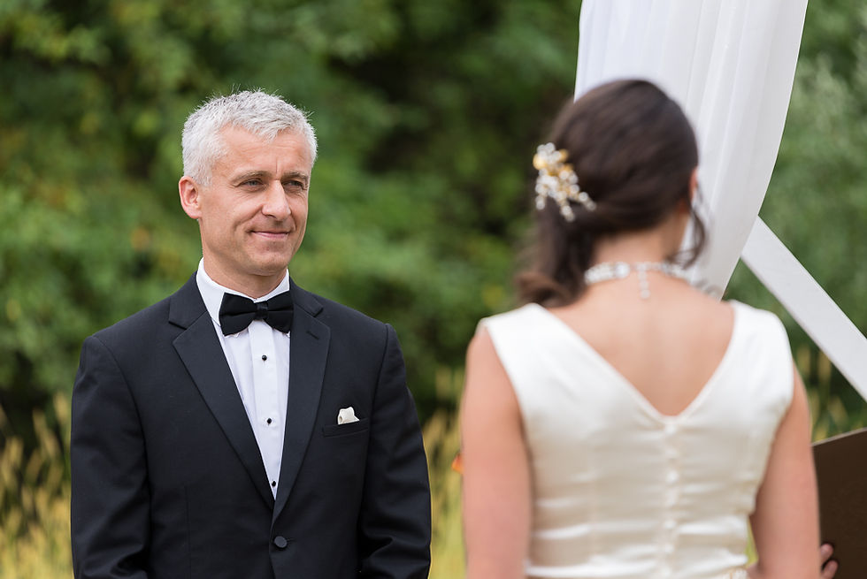 Andreas admires his bride during the ceremony