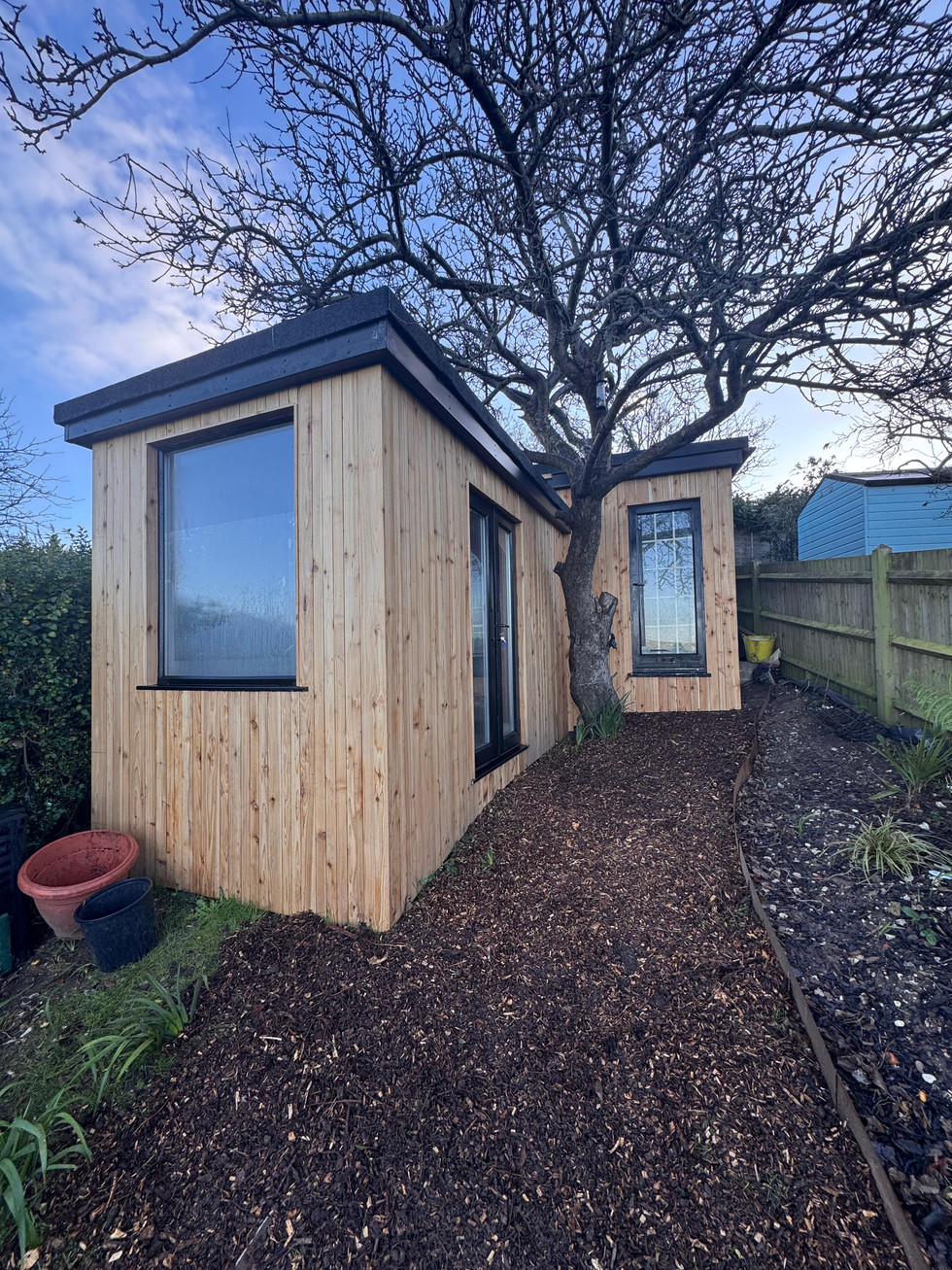 Cedar clad garden room with large front window