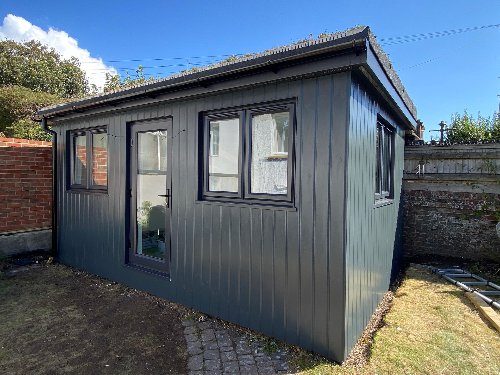 Side angle of black clad garden room