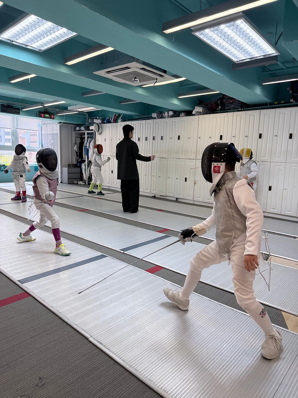 Close-up view of fencing mask and foil on a training table