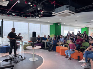 A speaker giving a presentation to a team in a modern office setting, showcasing how automated AI tools can enhance workplace collaboration and efficiency.