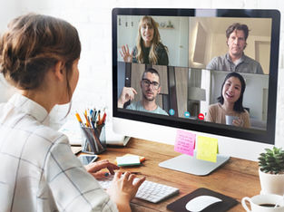 A remote team video conference call with four professionals discussing collaboration strategies, representing global teamwork and offshore talent integration.