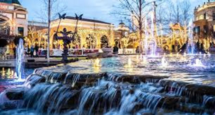 Downtown Meridian clock tower with people walking and local shops in view