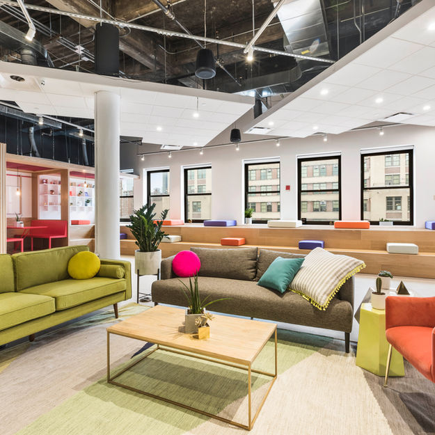 Renovated corporate office with contemporary furnishings and improved lighting.