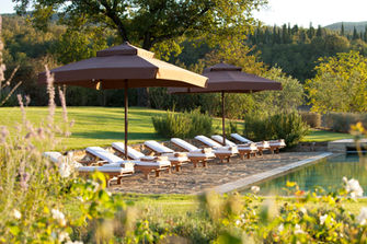 Poolside lounge chairs at the Castiglion del Bosco in Siena Italy