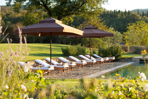 Poolside lounge chairs at the Castiglion del Bosco in Siena Italy
