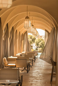 Hallway with arches and linen curtains