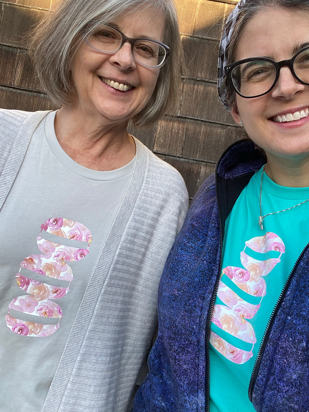 Chelsea and her mom wearing similar watercolor rose macaron stack tee shirts