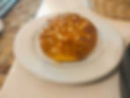A delicious and fluffy brioche bread on a white plate.