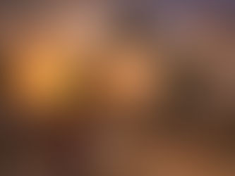 Tourists watching Mayan dancers perform under the Portal Maya sculpture in Playa del Carmen at sunset.