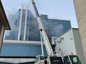 A crane is hoisting heavy machinery