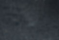 Dark, coarse asphalt surface with small light grey specks texture.