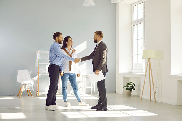 Couple shaking hands with a property manager