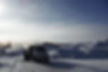 White truck on snowy road with snowbanks