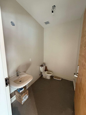 Small bathroom with freshly painted white walls and sink.