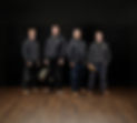 Team of four men in hoodies