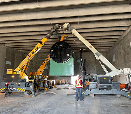 The cranes are lifting heavy machinery