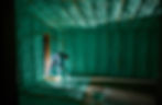Worker spraying green foam insulation