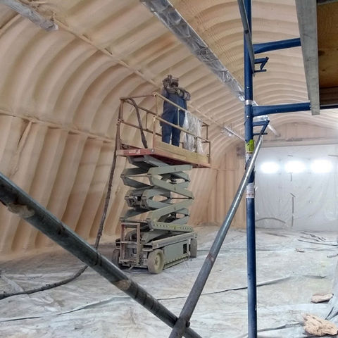 Agricultural insulation sprayed onto curved ceiling