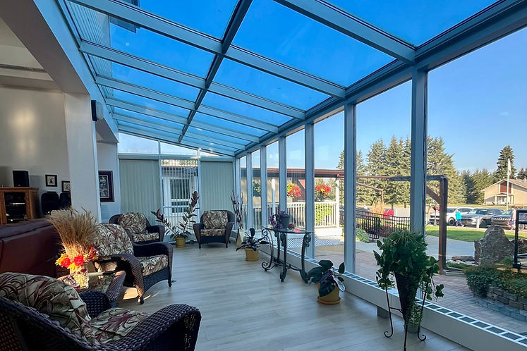 Sunroom at Homestead Lodge with glass roof and seating