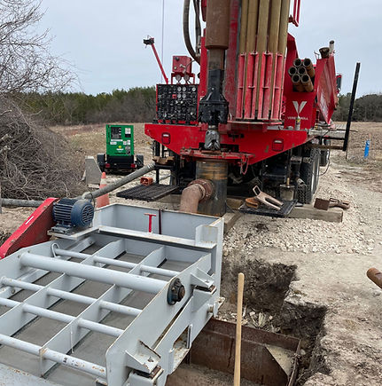 Red well drilling rig at a construction site