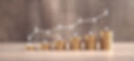 Stacks of coins with an upward trend line
