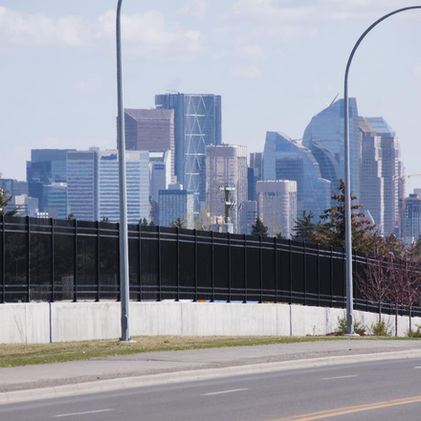 Distant cityscape with tall buildings, blue sky over Calgary, Alberta, Canada.
