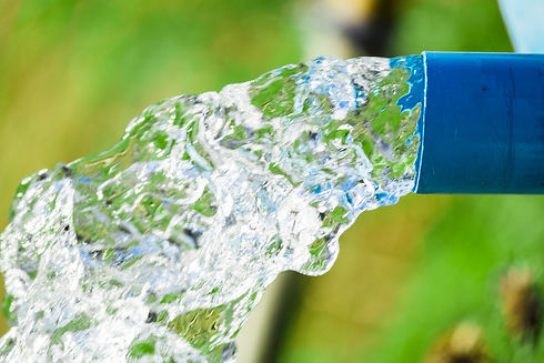 Water flowing from a blue hose after pump repair
