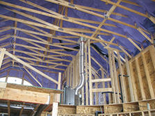 Interior roof framing with blue membrane