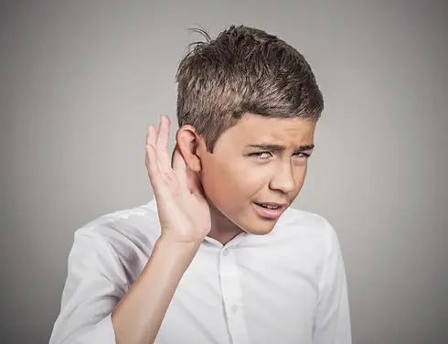Boy cupping ear, possibly with hearing loss