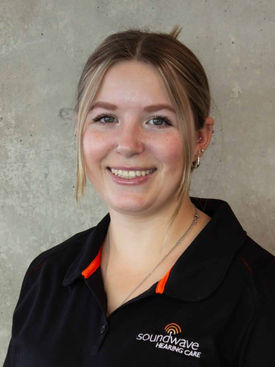 Smiling young woman in black polo shirt